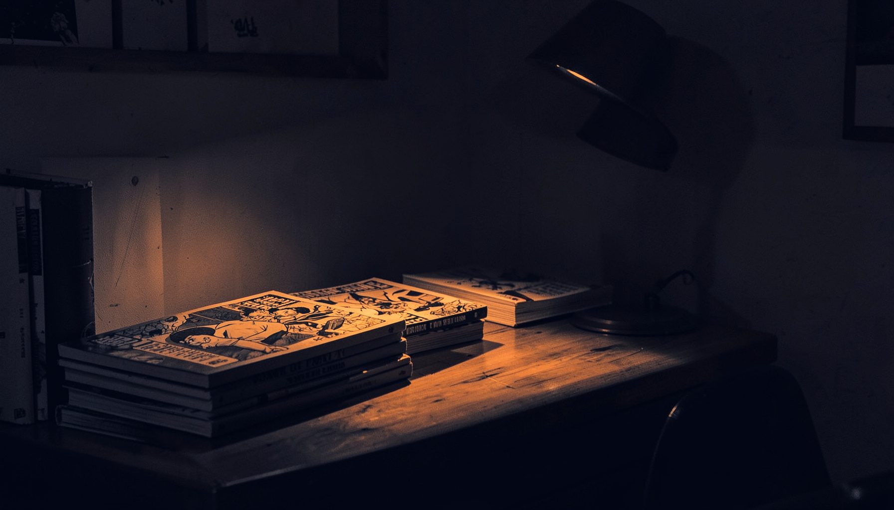 A duotone photograph of a dimly lit comic-book reading nook: stacked graphic novels on a wooden table, a warm amber reading lamp casting long shadows, deep navy and burnt-orange tones.