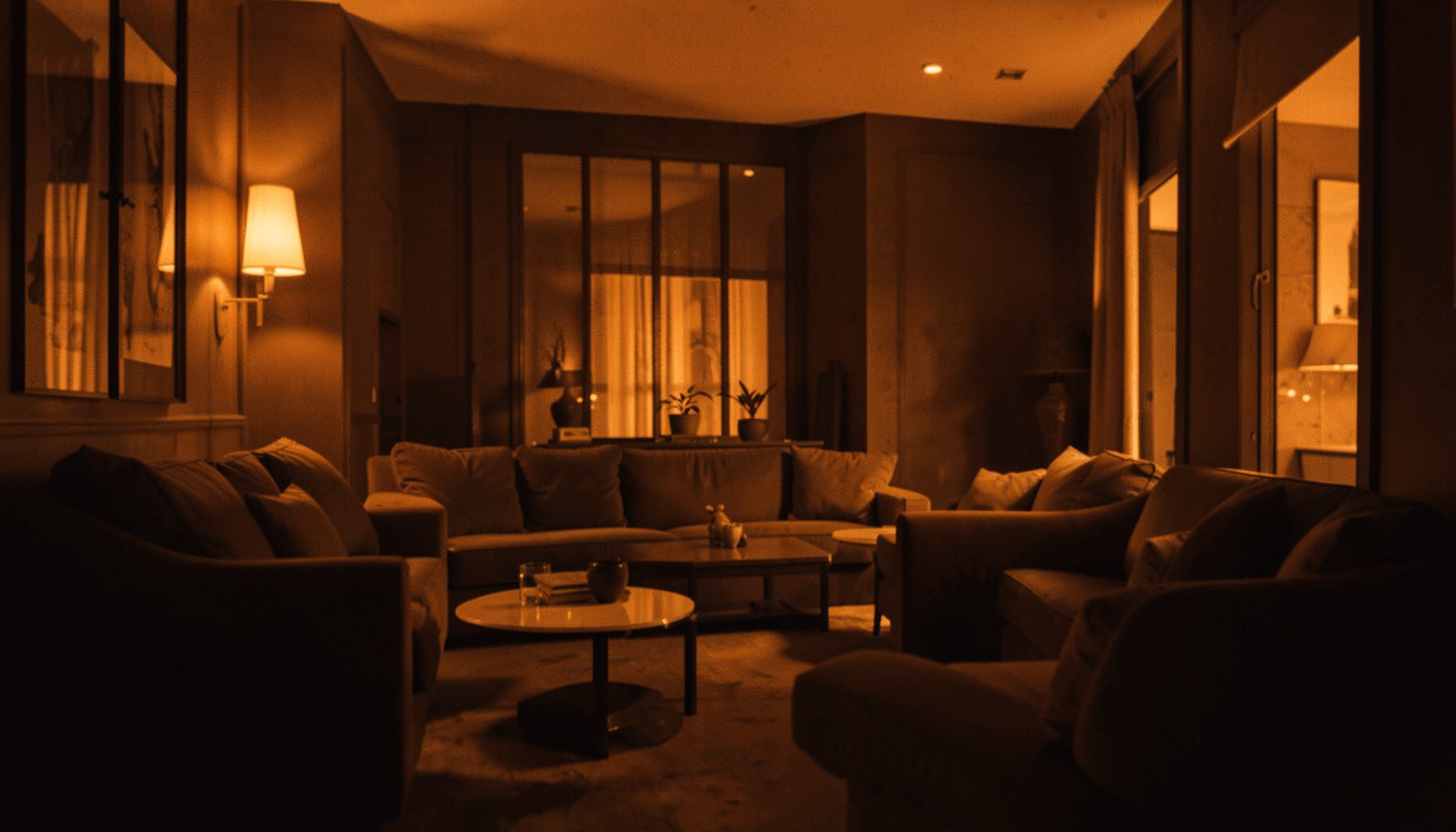 A warm atmospheric photograph of a lounge interior with soft amber lighting and deep shadows, calm and sophisticated mood in a hard two-tone duotone